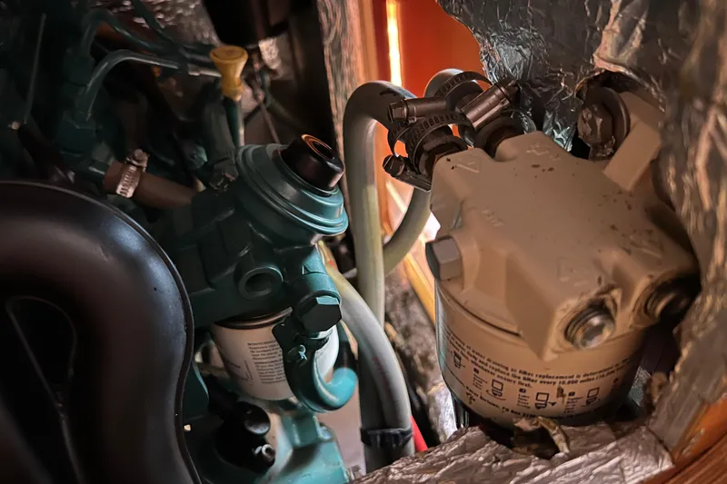 Slide: The Image of Engine components of a 2007 Delphia 33 Sloop, featuring hoses and filters. - 106