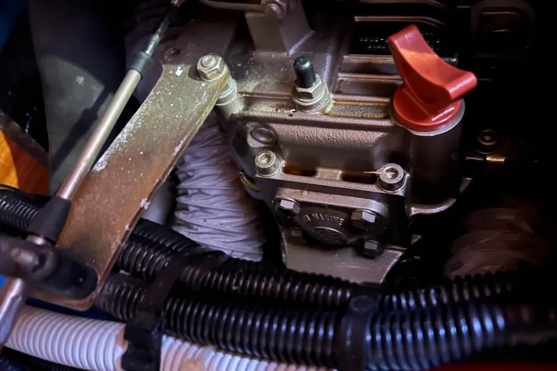 Slide: The Image of Engine components of a 2007 Delphia 33 Sloop, featuring red lever and metal parts. - 108