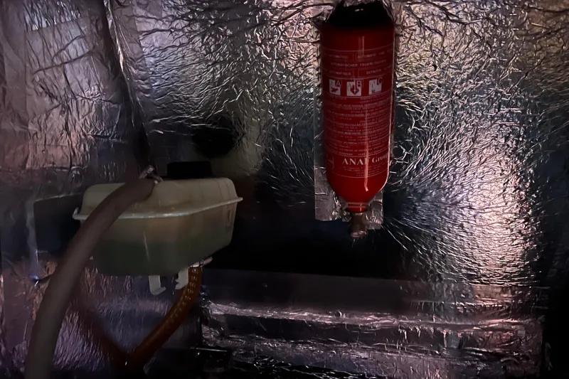 Slide: The Image of Engine compartment of 2007 Delphia 33 Sloop with fire extinguisher and coolant reservoir. - 110