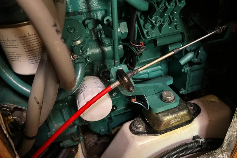 Slide: The Image of Engine compartment of a 2007 Delphia 33 Sloop, showcasing mechanical components and wiring. - 111