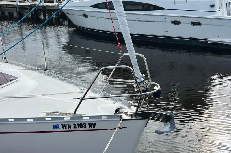 Slide: The Image of Delphia 33 Sloop 2007 docked, featuring sleek design and visible registration number. - 13