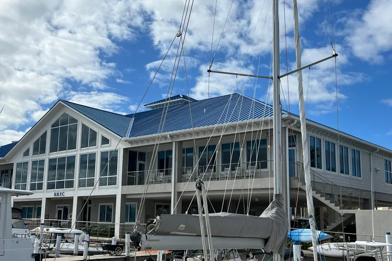 Slide: The Image of Sailboat docked near a marina building under a blue sky, Delphia 33 Sloop, 2007. - 16
