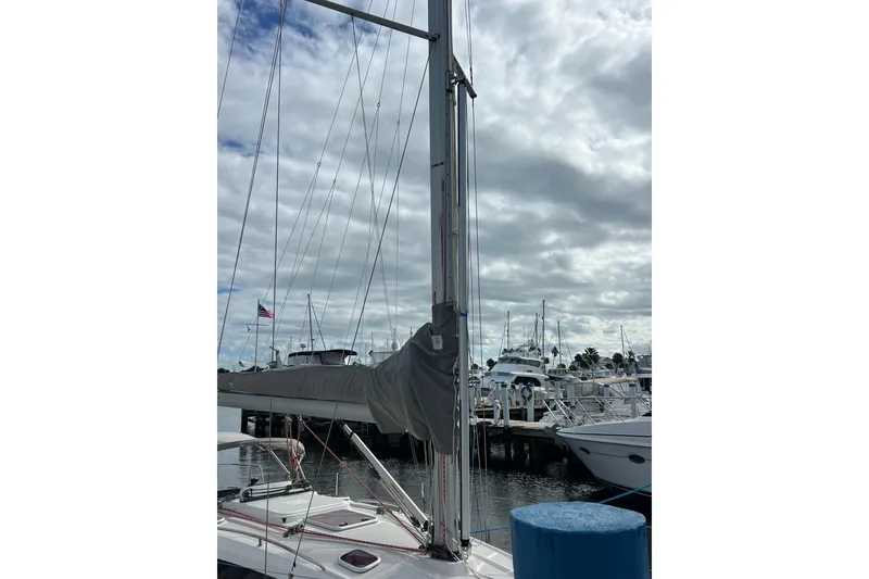 Slide: The Image of 2007 Delphia 33 Sloop sailboat docked at marina under cloudy sky. - 20