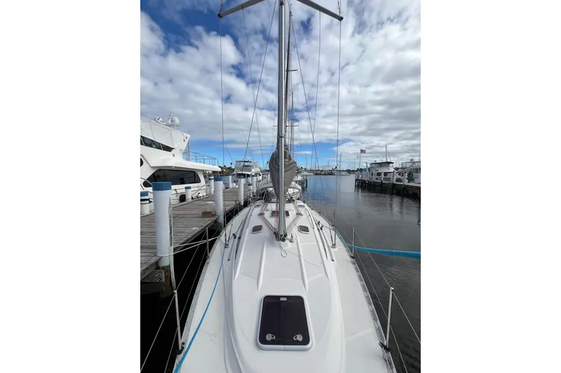 Slide: The Image of 2007 Delphia 33 Sloop docked at marina under cloudy sky. - 34