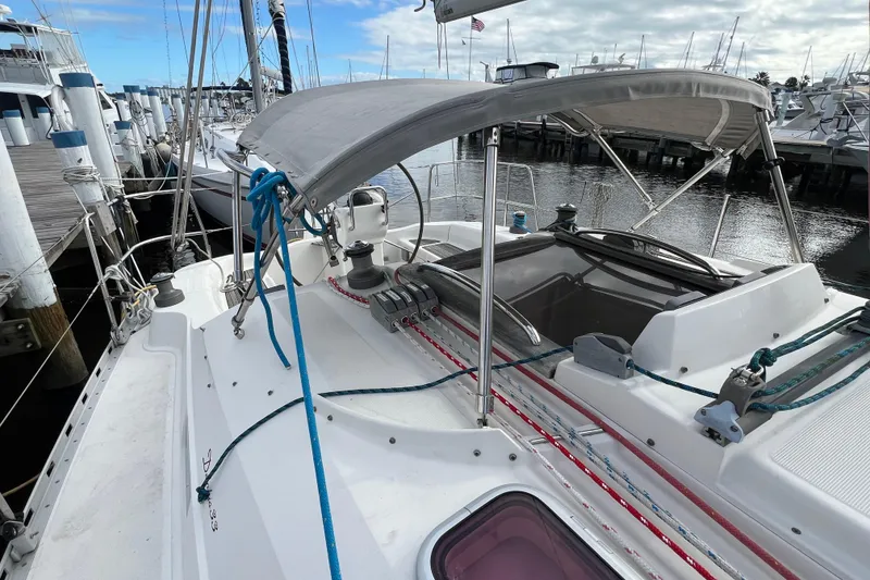 Slide: The Image of 2007 Delphia 33 Sloop sailboat docked at marina, featuring deck and rigging. - 35