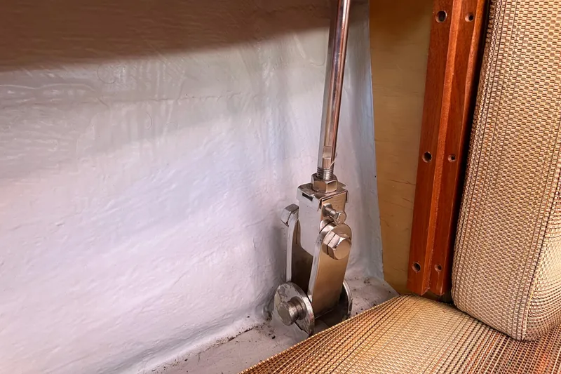 Slide: The Image of Interior view of 2007 Delphia 33 Sloop, showcasing metal fittings and upholstery details. - 42