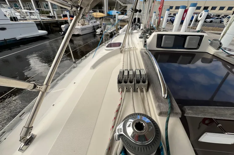 Slide: The Image of 2007 Delphia 33 Sloop deck with winch and rigging details at marina. - 49