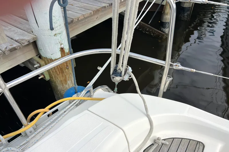 Slide: The Image of Delphia 33 Sloop (2007) docked, showing deck and rigging details. - 51