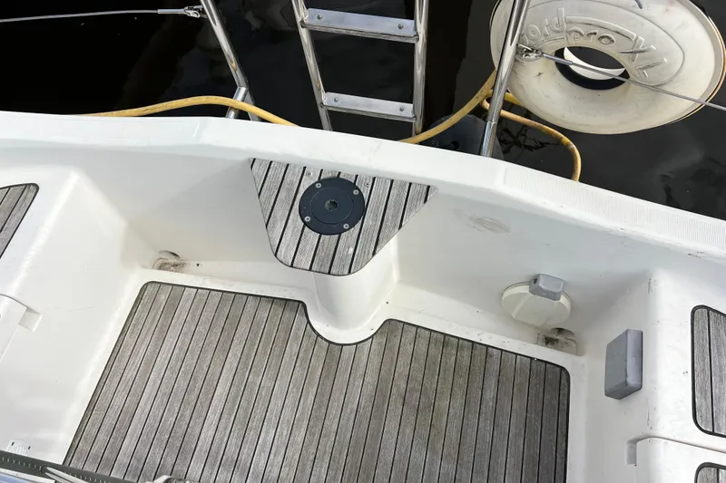 Slide: The Image of 2007 Delphia 33 Sloop deck with wooden flooring and safety equipment. - 52