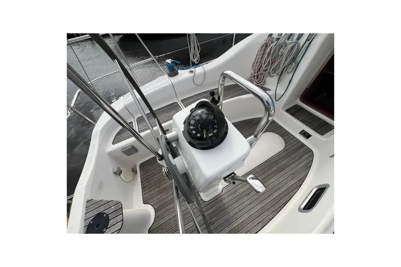 Slide: The Image of 2007 Delphia 33 Sloop cockpit with compass and teak flooring. - 57