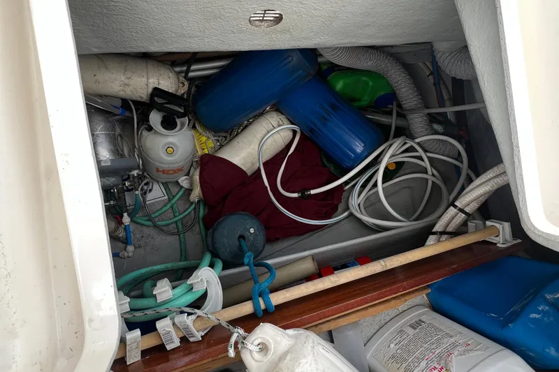 Slide: The Image of Storage compartment of a 2007 Delphia 33 Sloop with hoses and equipment. - 62