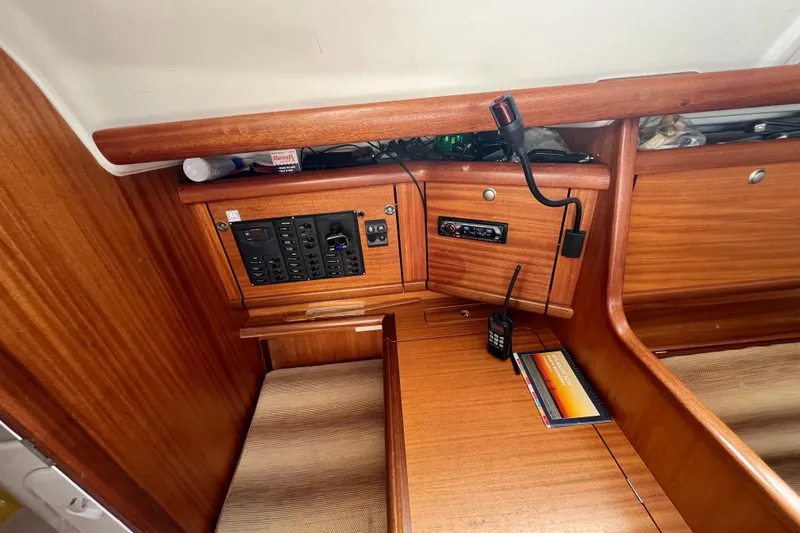 Slide: The Image of Interior of 2007 Delphia 33 Sloop with navigation panel and wooden finish. - 73