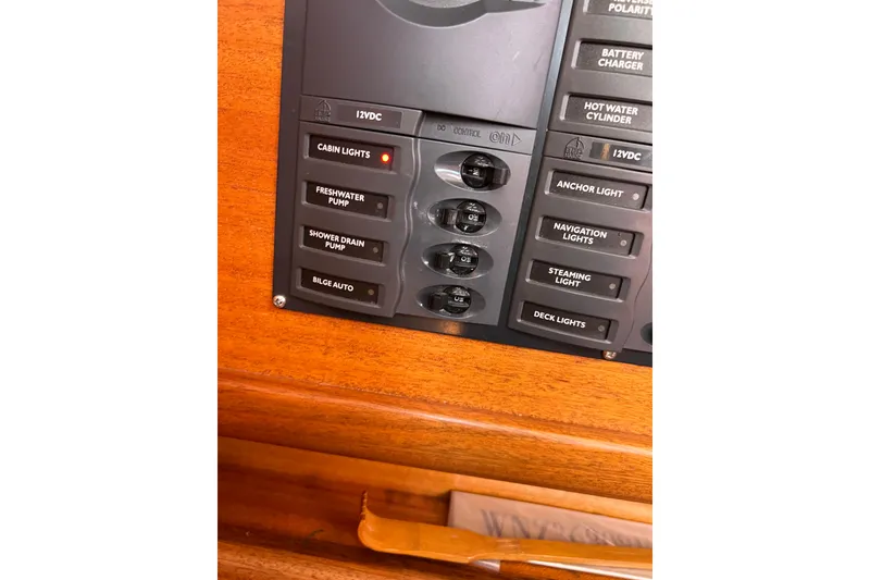 Slide: The Image of Control panel of a 2007 Delphia 33 Sloop, featuring various switches and indicators. - 75