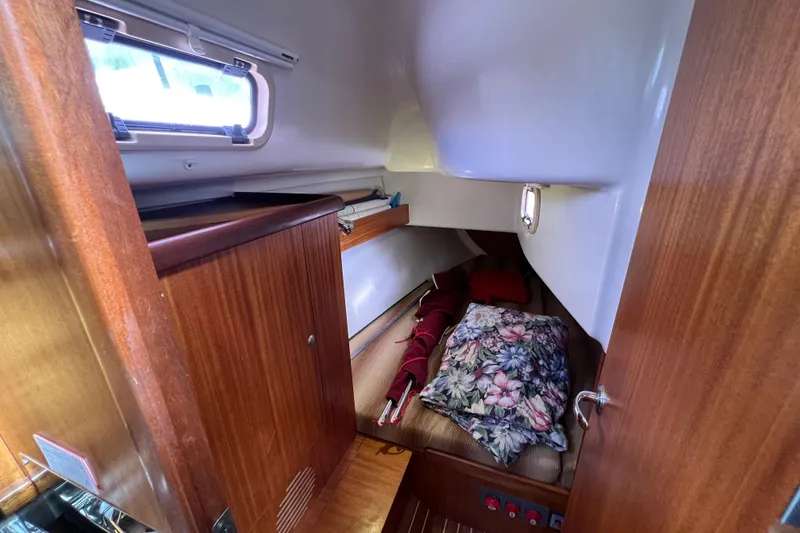 Slide: The Image of Cozy cabin interior of 2007 Delphia 33 Sloop with floral bedding and wooden finishes. - 78