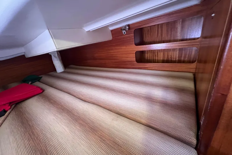 Slide: The Image of Interior cabin of 2007 Delphia 33 Sloop with wooden finish and cushioned seating. - 79
