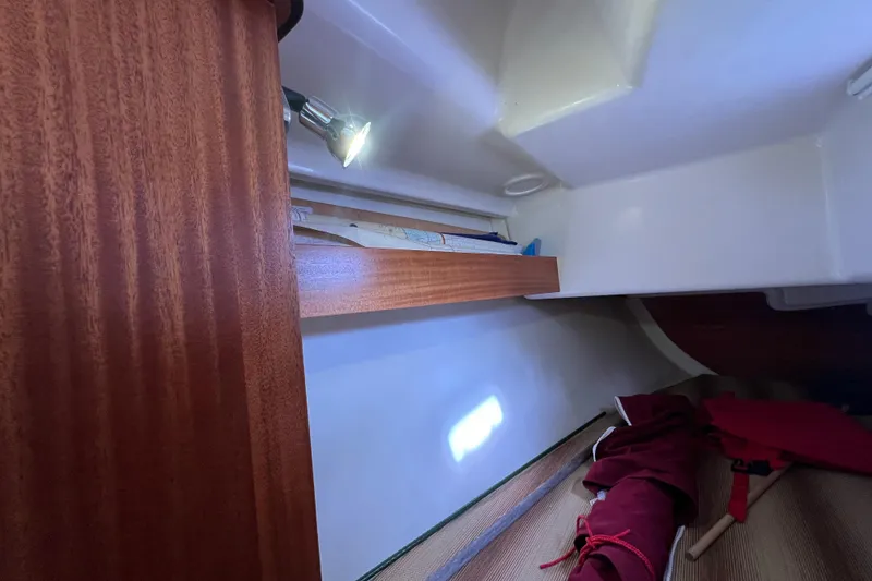 Slide: The Image of Interior of 2007 Delphia 33 Sloop with wooden shelf and cozy cabin space. - 80