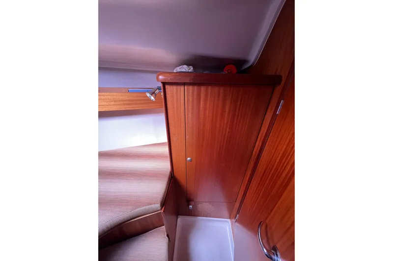 Slide: The Image of Interior cabin of 2007 Delphia 33 Sloop with wooden cabinetry and seating. - 87