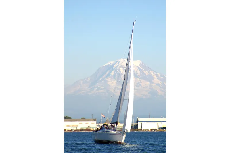 Slide: The Image of Sailing Delphia 33 Sloop (2007) with mountain backdrop on a clear day. - 9