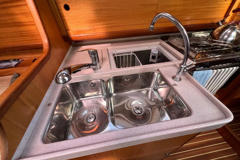 Slide: The Image of Galley sink area in 2007 Delphia 33 Sloop yacht with stainless steel fixtures. - 90