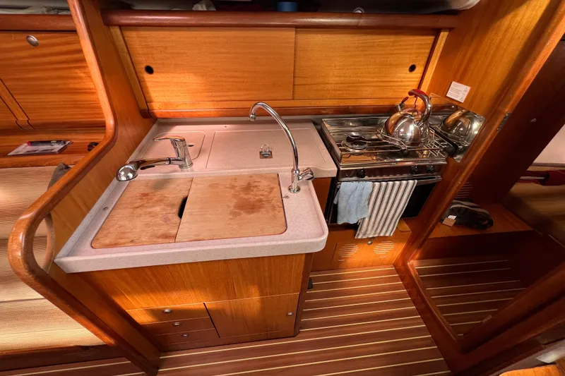 Slide: The Image of Compact kitchen in 2007 Delphia 33 Sloop with sink, stove, and wooden cabinetry. - 91