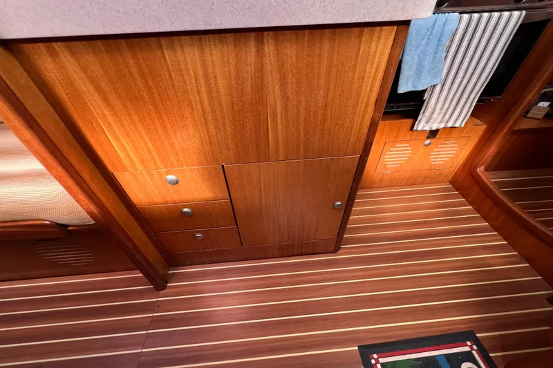 Slide: The Image of Interior of 2007 Delphia 33 Sloop with wooden cabinetry and striped flooring. - 94