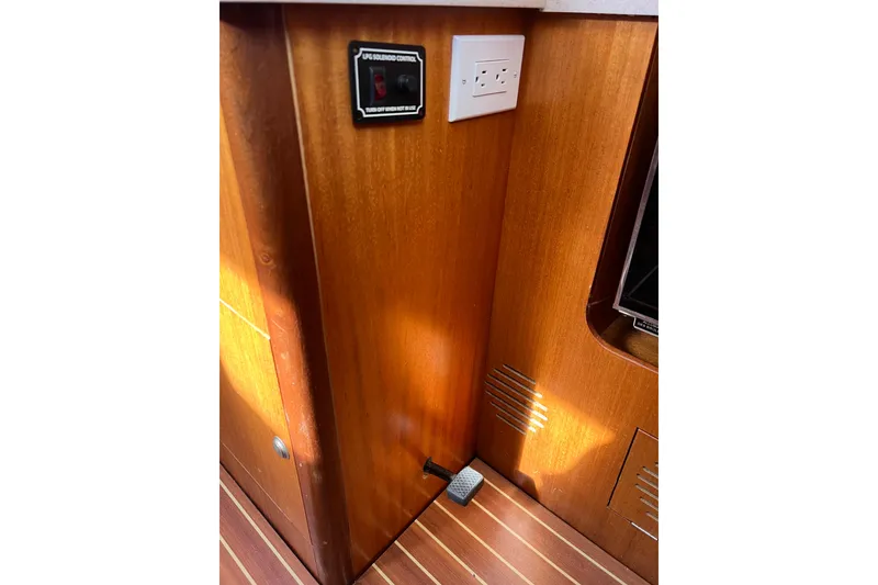 Slide: The Image of Interior of 2007 Delphia 33 Sloop with wood paneling and electrical outlet. - 96