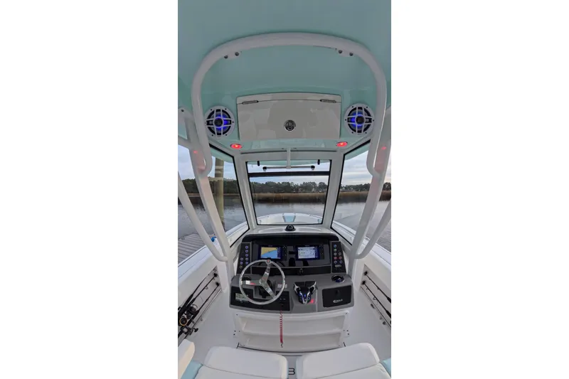 Slide: The Image of 2025 Robalo R250 Center Console boat docked at sunset, featuring spacious seating and sleek design. - 19
