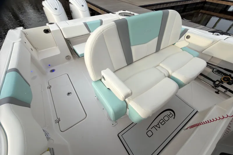 Slide: The Image of Robalo R250 Center Console 2025 on calm water at sunset. - 21