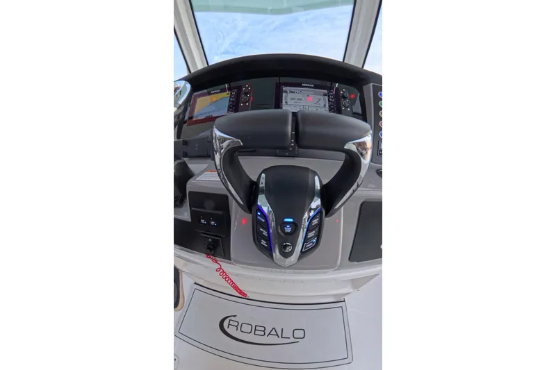 Slide: The Image of 2025 Robalo R250 Center Console helm with advanced controls and navigation display. - 31