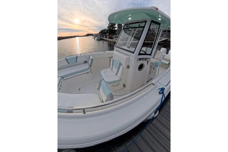 Slide: The Image of 2025 Robalo R250 Center Console boat cruising on open water under a bright sun. - 8