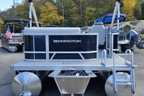 Slide: The Image of 2026 Bennington 20 SL pontoon boat displayed outdoors with trees in the background. - 4