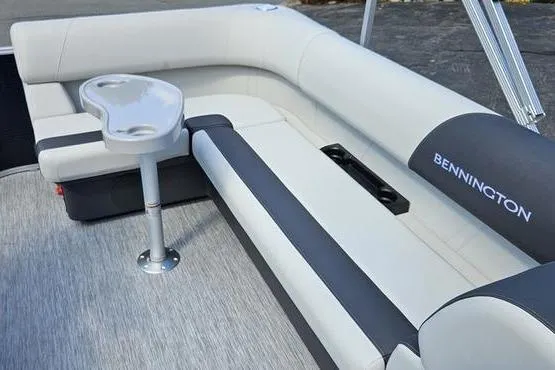 Slide: The Image of 2026 Bennington 20 SL boat interior with gray seating and cup holder. - 7