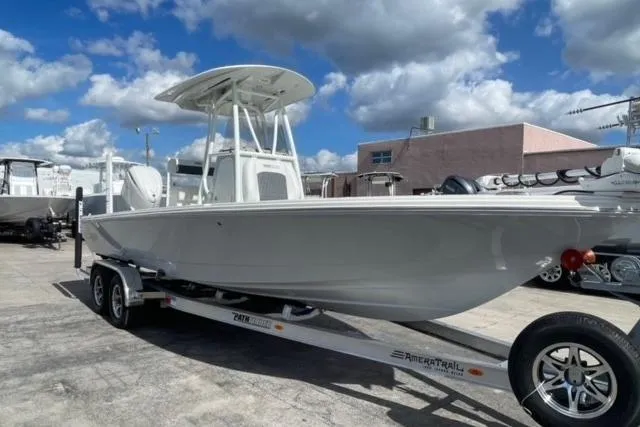 Slide: The Image of 2026 Pathfinder 2600 TRS boat on trailer under a blue sky with clouds. - 1