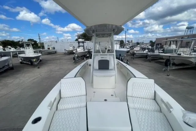 Slide: The Image of 2026 Pathfinder 2600 TRS boat with spacious seating, docked under a partly cloudy sky. - 10