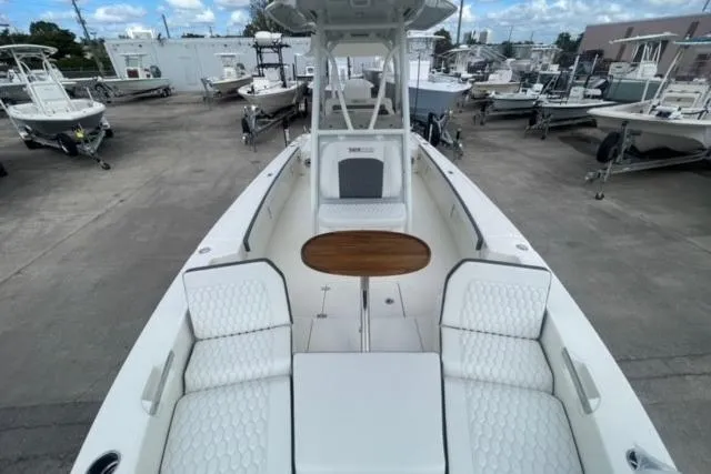 Slide: The Image of 2026 Pathfinder 2600 TRS boat with spacious seating and sleek design in a marina setting. - 12