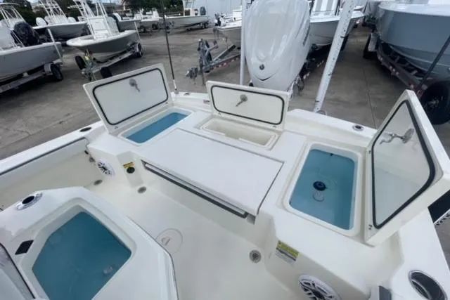 Slide: The Image of 2026 Pathfinder 2600 TRS boat interior with open storage compartments and seating. - 16