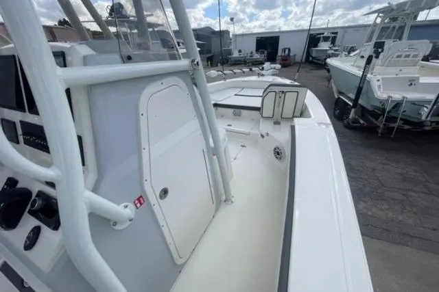 Slide: The Image of 2026 Pathfinder 2600 TRS boat interior with console and seating, docked outdoors. - 19