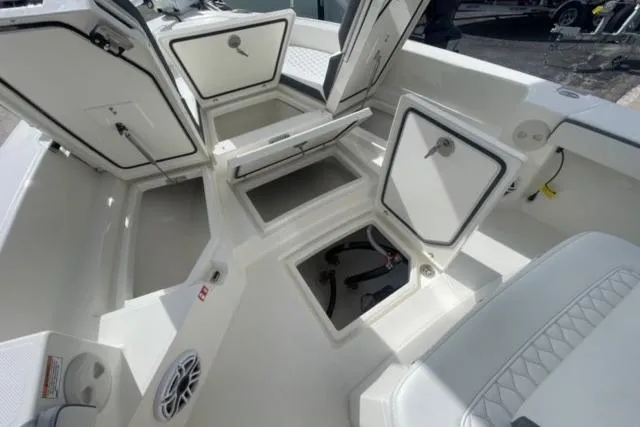Slide: The Image of 2026 Pathfinder 2600 TRS boat interior with open storage compartments and seating. - 22