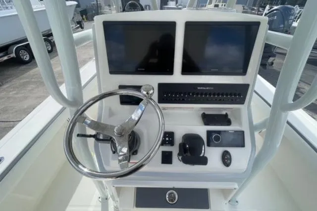 Slide: The Image of 2026 Pathfinder 2600 TRS boat console with dual screens and steering wheel. - 24