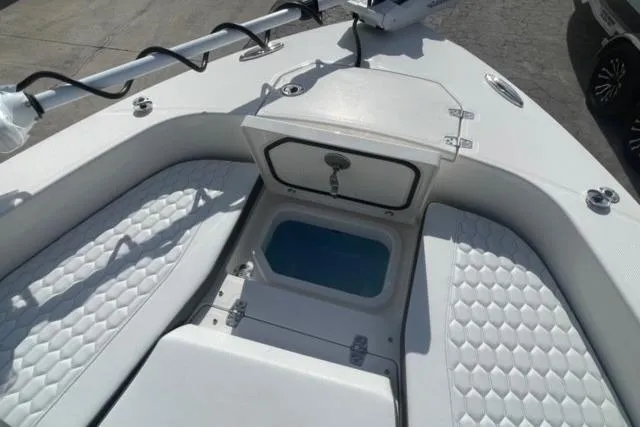 Slide: The Image of 2026 Pathfinder 2600 TRS boat interior with open storage compartment and cushioned seating. - 30