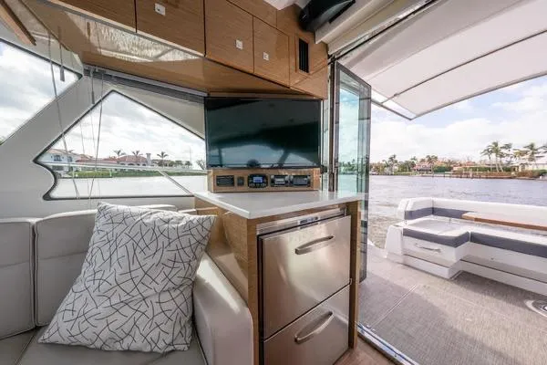 Slide: The Image of 2018 Cruisers Yachts 50 Cantius deck with scenic water view and modern amenities. - 10