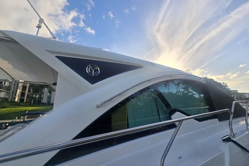 Slide: The Image of 2018 Cruisers Yachts 50 Cantius with sleek design against a vibrant sky backdrop. - 31