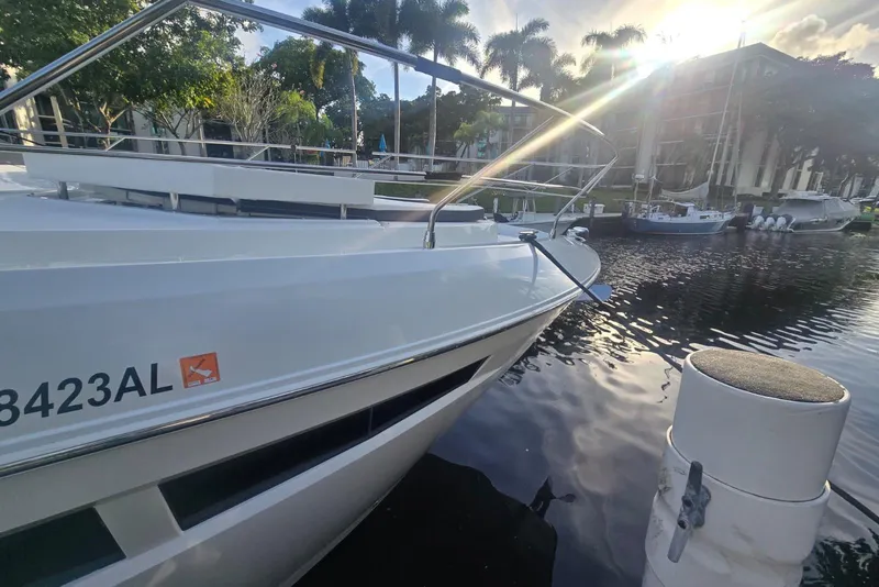 Slide: The Image of 2018 Cruisers Yachts 50 Cantius docked near palm trees and waterfront buildings. - 32