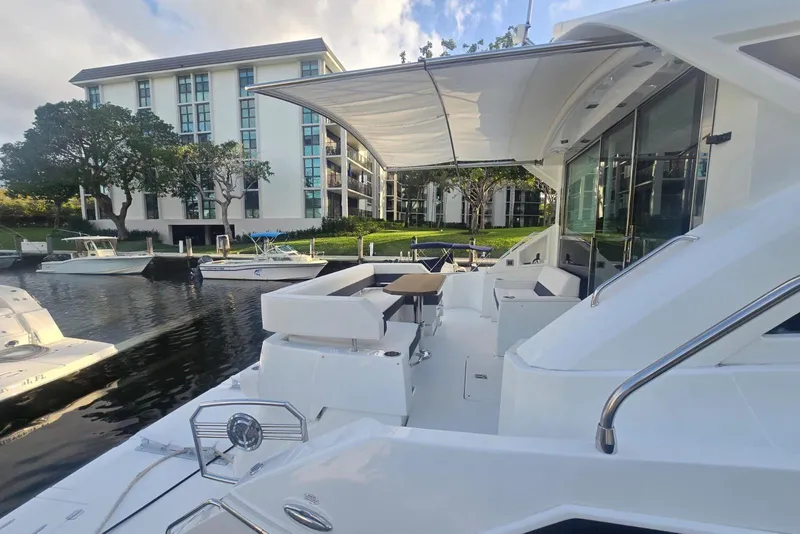 Slide: The Image of 2018 Cruisers Yachts 50 Cantius docked on a sunny waterfront. - 36