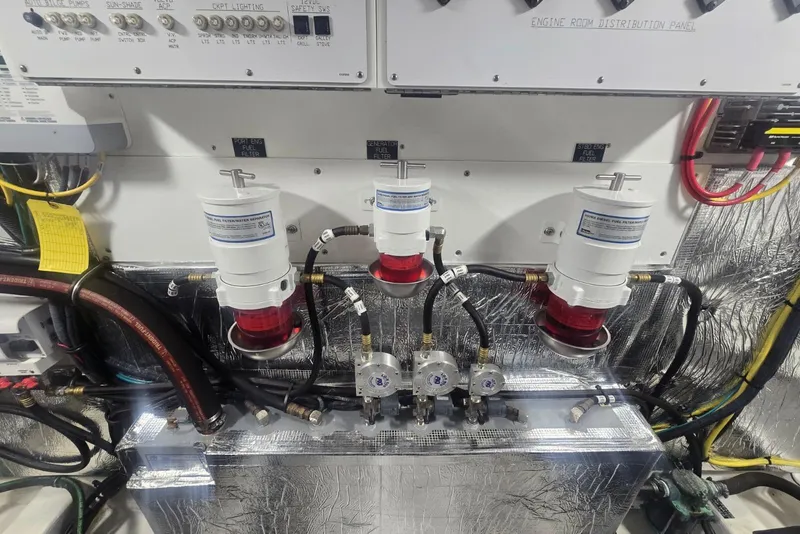 Slide: The Image of Engine compartment of 2018 Cruisers Yachts 50 Cantius, featuring mechanical components and piping. - 64