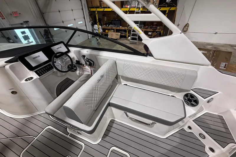 Slide: The Image of 2026 Sea Ray SDX 270 boat interior with modern dashboard and seating. - 11