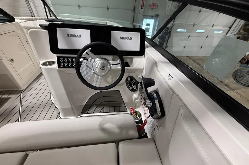 Slide: The Image of Interior view of 2026 Sea Ray SDX 270 boat cockpit with Simrad displays and steering wheel. - 12