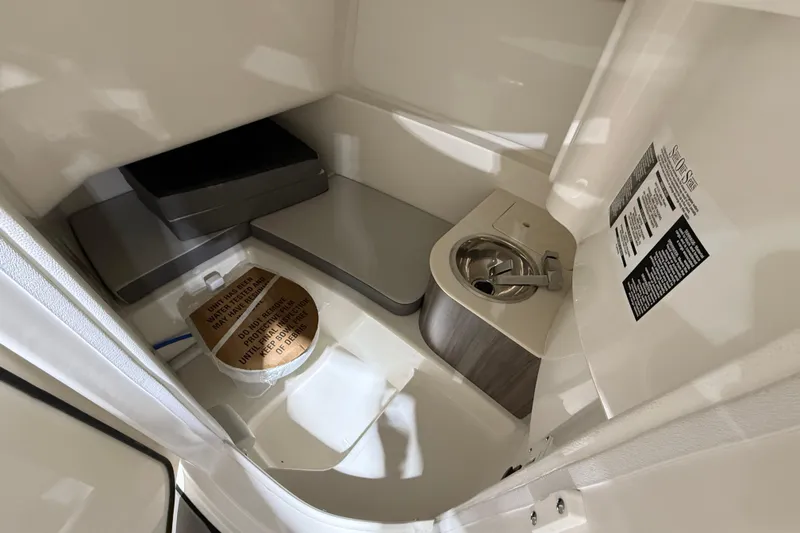 Slide: The Image of Interior of 2026 Sea Ray SDX 270 boat bathroom with sink and toilet. - 13