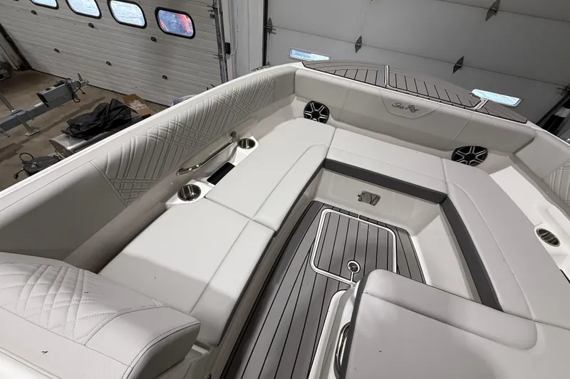 Slide: The Image of Luxurious interior of 2026 Sea Ray SDX 270 boat with plush seating and cup holders. - 17