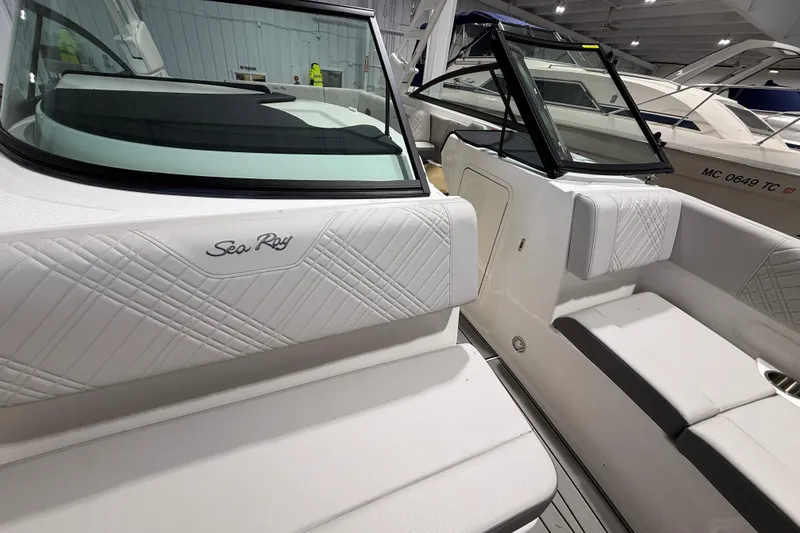 Slide: The Image of 2026 Sea Ray SDX 270 boat interior with white quilted seating and sleek design. - 21